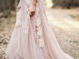 a blush lace A-line wedding dress with floral appliques looks beautiful and very dreamy