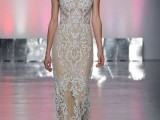 a nude lace sheath wedding dress with cap sleeves and an illusion neckline plus a train