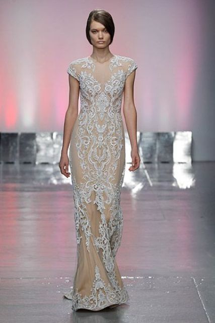 a nude lace sheath wedding dress with cap sleeves and an illusion neckline plus a train