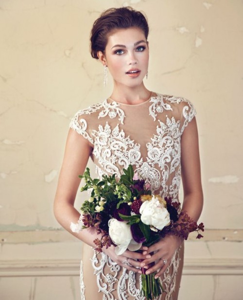 a glam nude lace fitting wedding dress with a high neckline and cap sleeves looks very chic and statement-like