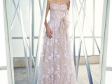 a strapless nude lace floral A-line wedding dress with appliques and a sash for a romantic and chic bridal look