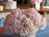 a wooden box with soft pink flowers is a cute rustic or barn wedding centerpiece