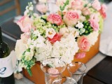 a plywood box with white and pink blooms and greenery plus some berries is a chic barn wedding centerpiece