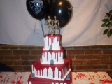 a bloody square wedding cake with grave stones and skeletons on top is a stylish idea for a Halloween wedding