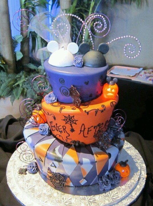 A purple and orange wedding cake with cut tiers, various patterns, letters and monograms, spiderwebs and Mickey Mouse toppers for fun