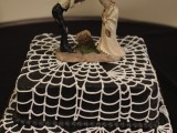 a black and white square spiderweb wedding cake with cool toppers is a stylish and simple idea for a Halloween wedding