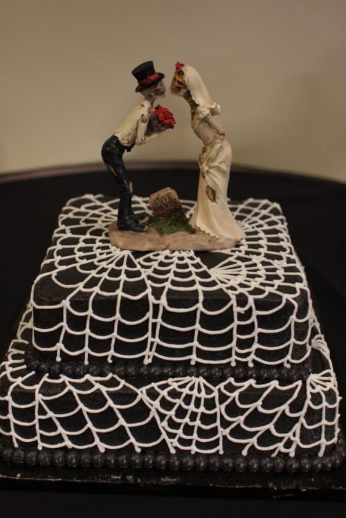 a black and white square spiderweb wedding cake with cool toppers is a stylish and simple idea for a Halloween wedding