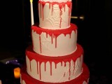 a white spiderweb wedding cake with blood and with zombie and Frankenstein toppers for a Halloween wedding