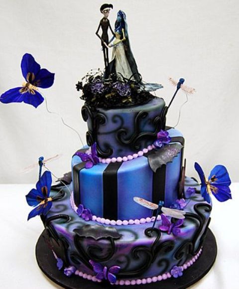a black, blue and purple Halloween wedding cake with different patterns, butterflies and creative Sally and Jack Skellington toppers
