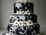 a unique black and white wedding cake with white sugar blooms is a stylish idea for Halloween