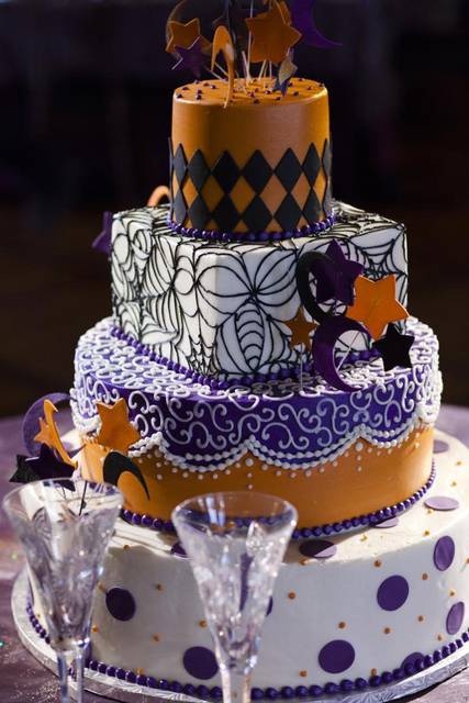 a white, purple and orange wedding cake with unique patterns, polka dots, sugar stars and moons is a bright and fun idea for Halloween