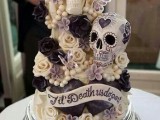 a crazy pastel wedding cake with sugar blooms, skulls and signs, butteflies and beads is a unique idea for Halloween
