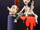 a black wedding cake with blood drips, a scary tree and fun Sally and Jack Skellington toppers for a Halloween wedding