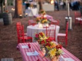 a colorful summer picnic with simple furniture, bright blooms and plaid textiles is a cool idea for a rustic rehearsal