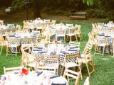 a rustic picnic setting with yellow furniture and plaid textiles, bright blooms for a summer rehearsal