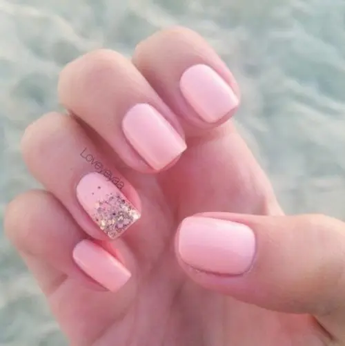 a light pink wedding manicure with an accent nail done with gold glitter is a lovely idea for a glam and cool bridal look