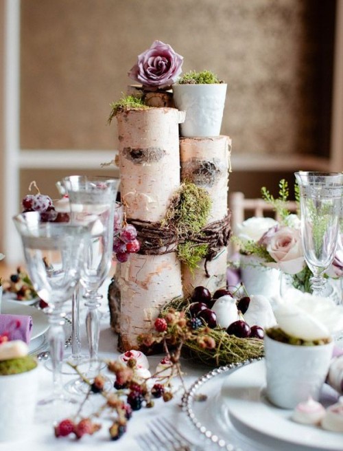 a fall woodland wedding centerpiece of tree stumps, berries, moss, vines and much more is a very cool and fresh idea