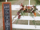 fall woodland wedding decor with greenery, bold leaves, antlers and blooms is a lovely idea to rock