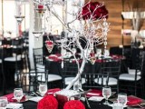 a black and red wedding tablescape with silver touches and a whitewashed tree with crystals hanging