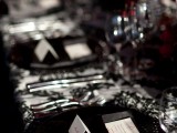 a black and white wedding tablescape spruced up with lush red florals and patterns