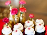chocolate cupcakes with icing and pink touches, gold vases with pink blooms to highlight the color scheme