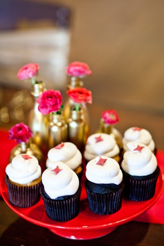 Chocolate cupcakes with icing and pink touches, gold vases with pink blooms to highlight the color scheme