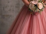 a strapless wedding dress with a gold sequin bodice and a pink tulle midi skirt for a touch of glam at the wedding