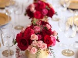 red and pink floral centerpieces with berries in gold vases are amazing to add color to your tables