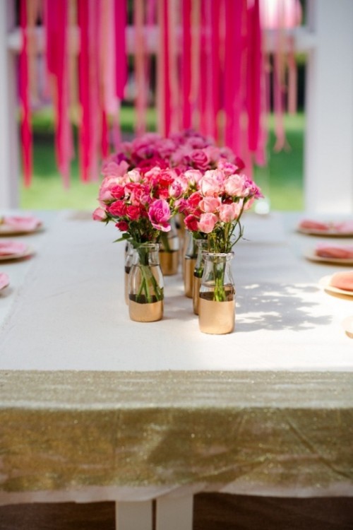 pink, red and blush blooms in bottles with touches of gold are simple and cute wedding centerpieces