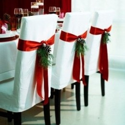 white chairs with red ribbon and evergreens are amazing for a winter wedding, accent your chairs and make them cooler