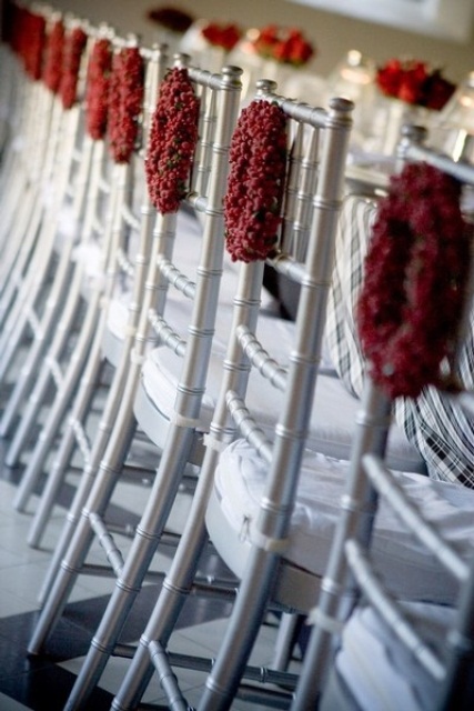 red berry wreaths are great to style your wedding chairs in winter, they will add a touch of color