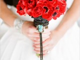 a red anemone wedding bouquet is a nice touch of color to the bridal look or a bridesmaid one