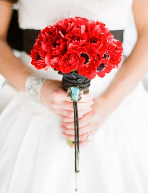 a red anemone wedding bouquet is a nice touch of color to the bridal look or a bridesmaid one