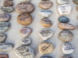 pebbles as escort cards are a very cool boho beach wedding idea that is easy to DIY