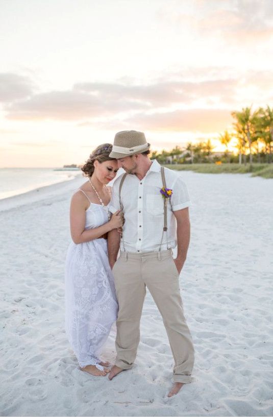 a boho beach maxi wedding dress with paghetti straps, a necklace of shells and a braided hairstyle