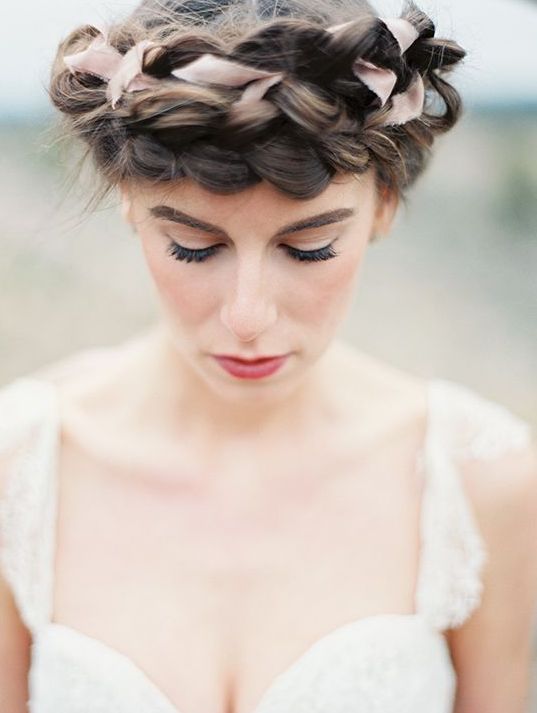 A double braided halo with a pink ribbon on top is a refined and chic idea for a boho bride or for some other bridal style