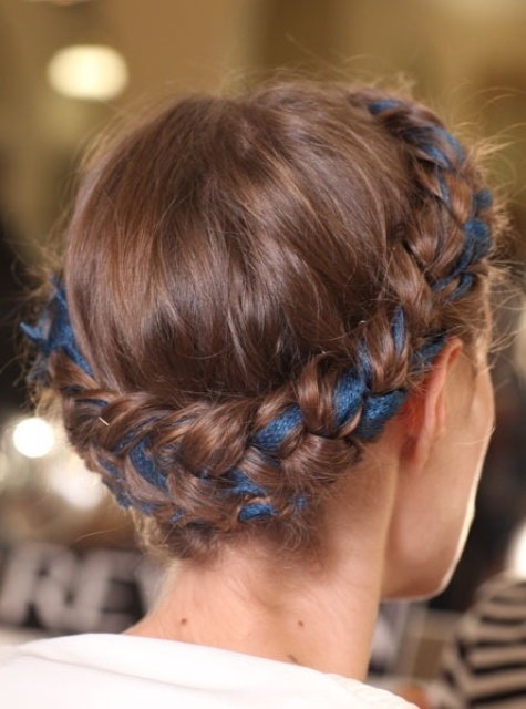 a braided halo updo interwoven with a navy ribbon for more eye-catchiness is a beautiful idea for a boho bride