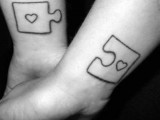 large black and white puzzle tattoos with hearts on the wrists are creative and cool options to rock