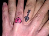 a heart-shaped and key-shaped tattoo as couple tattoos on the ring figers are a fun and bold idea instead of usual rings