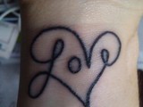 a large LOVE and heart tattoo on the wrist is a cool statement on your wedding day