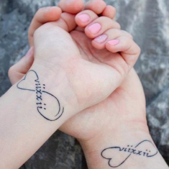 Heart tattoos with the wedding date done in Roman numbers are lovely and chic, they are simple and black, with cool shapes