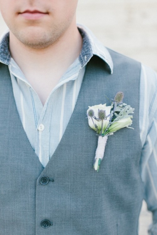 a striped pale blue shirt plus a grey waistcoat and a boutonniere are a lovely combo for a groom