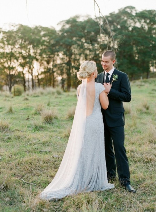a pale blue embellished wedding dress with cap sleeves and a cutout back plus a train is a beautiful idea for a wedding