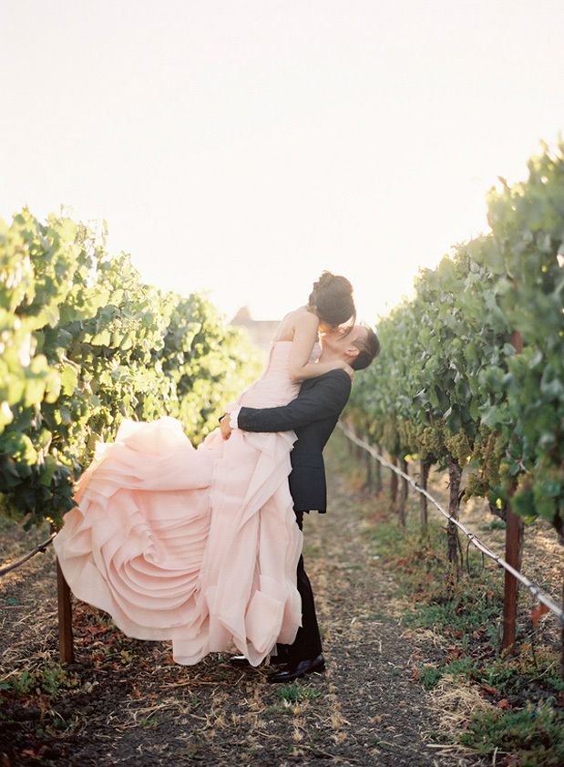 A pink strapless wedding dress with a layered skirt that imitates a flower is a veyr cute and girlish idea