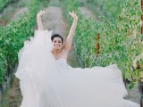 a strapless wedding ballgown with a draped bodice and a layered skirt with a train is very chic