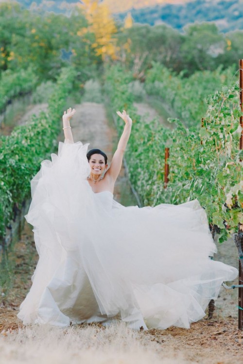 a strapless wedding ballgown with a draped bodice and a layered skirt with a train is very chic