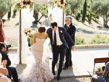 a blush strapless mermaid wedding dress with a ruffled skirt is a very chic and romantic idea