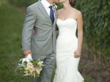 a strapless sheath wedding dress with a draped bodice and a lace skirt is a stylish and chic idea