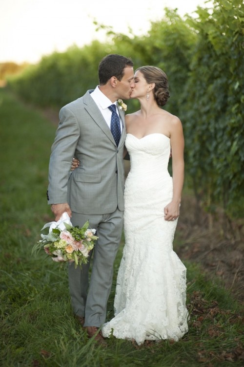 a strapless sheath wedding dress with a draped bodice and a lace skirt is a stylish and chic idea
