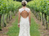 a lace sheath wedding dress with no sleeves, a cutout back and a high neckline plus a train